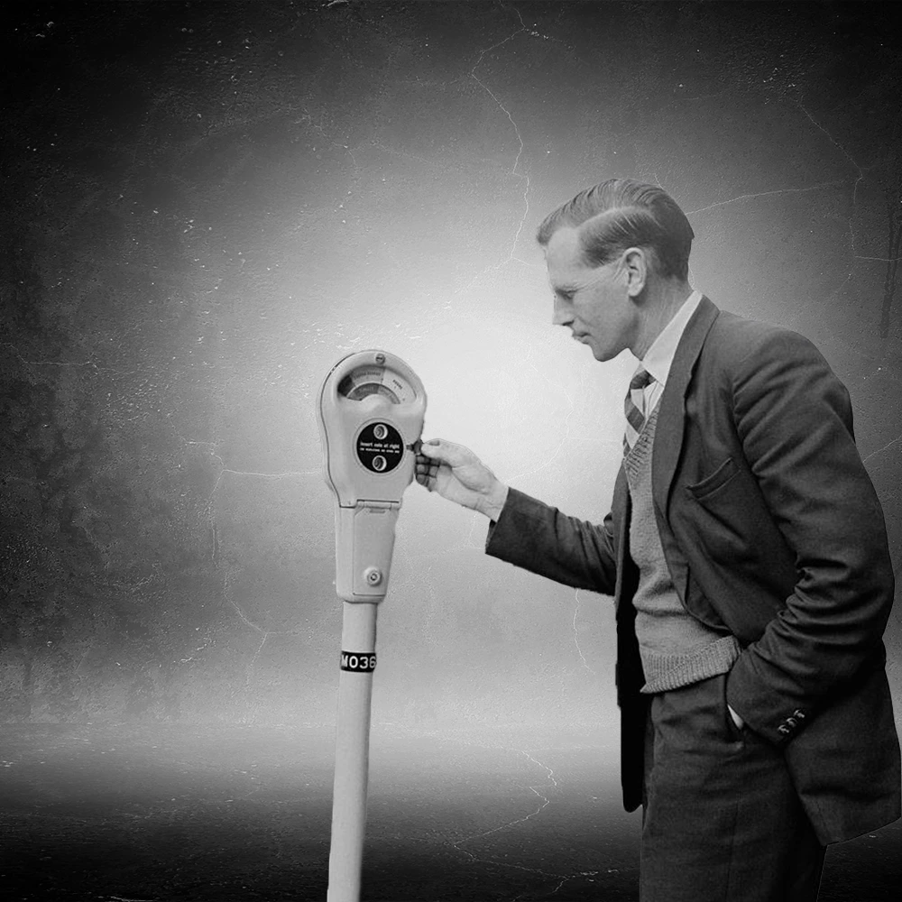 Parking Metre A black-and-white image of a man using a vintage coin-operated parking meter representing early parking payment technology.